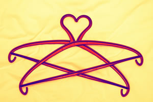 Image of two clothes hangers stacked to create a heart shape